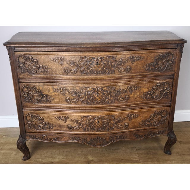 This elegant Vintage French Louis chest of drawers showcases beautifully carved detailing across each drawer front, with...