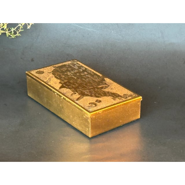 This metal cigarette box is one smokin' vintage tobacciana collectible. The brass metal cover has an engraved pictorial...