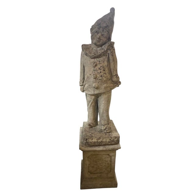 This charming vintage garden sculpture depicts a classic Pierrot (or Harlequin jester) standing gracefully atop a square...