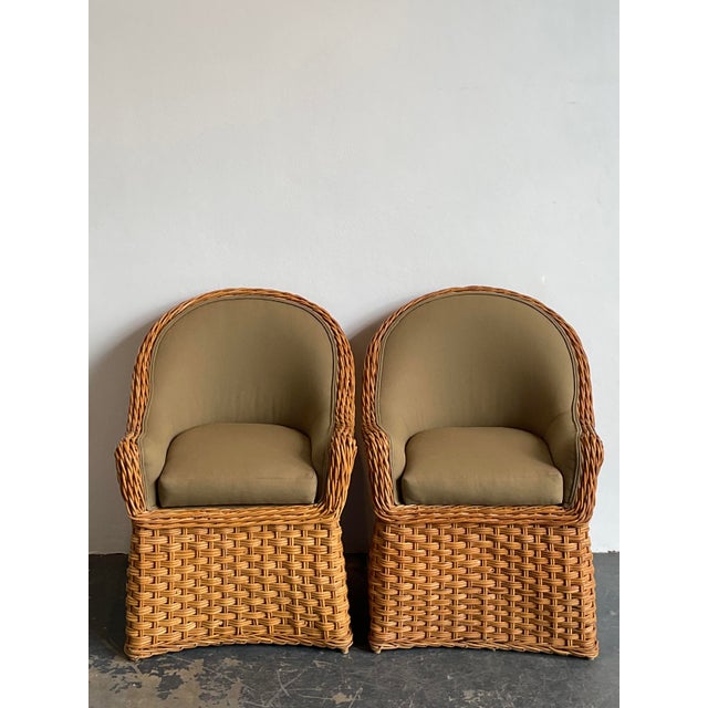 This pair of vintage woven rattan lounge chairs exudes a sophisticated coastal charm, blending organic textures with a...