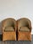 This pair of vintage woven rattan lounge chairs exudes a sophisticated coastal charm, blending organic textures with a...