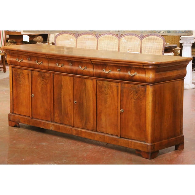This elegant antique French Louis Philippe sideboard brings refined 19th Century craftsmanship and generous storage to a...