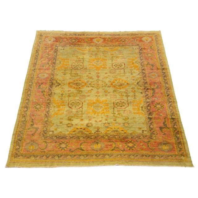 This hand-knotted wool rug features a stunning Vintage Oushak design. Its elegant olive green field is accompanied by...
