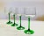 An elegant set of late 20th century stemware which presents a crisp aesthetic with its fresh green stem and slightly...
