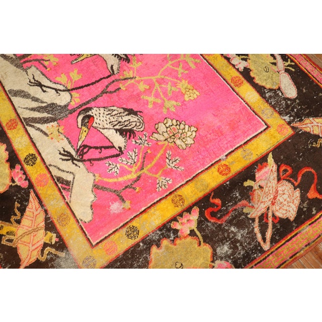 Late 19th Century distressed antique samarkand khotan rug with 4 flamingos hovering over a bright pink ground 5'10'' x 10'.