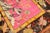 Late 19th Century distressed antique samarkand khotan rug with 4 flamingos hovering over a bright pink ground 5'10'' x 10'.