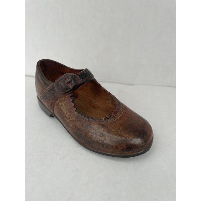 Solid bronze vintage Maryjane shoe.. This looks adorable as part of a shoe sculpture collection or simply atop a stack of...