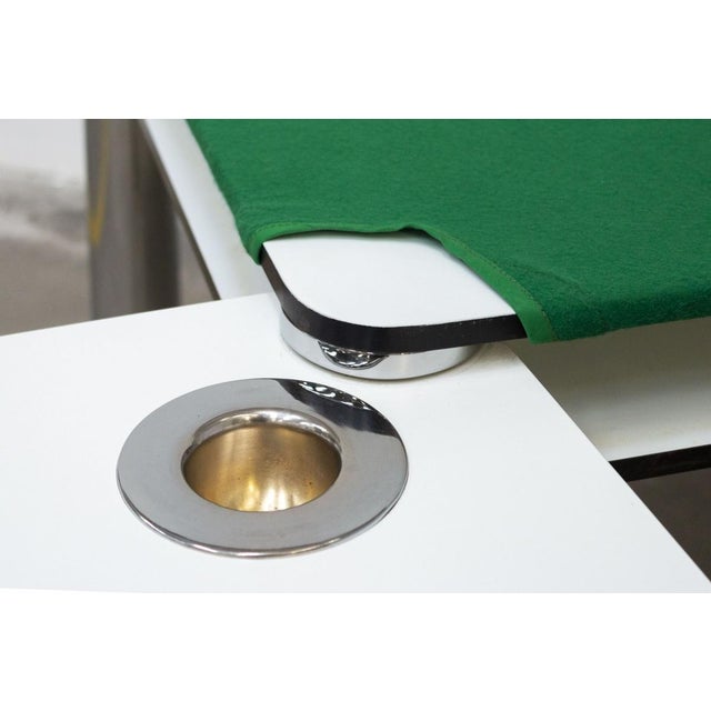 Game table. Tops in stratified plastic laminate, white color. Removable green cloth. Legs in 18/8 stainless steel. The...