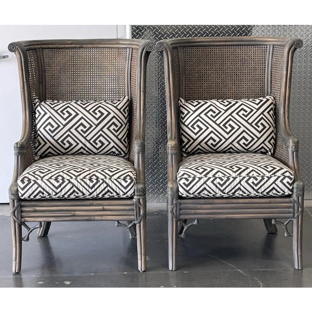 A dramatic and beautifully scaled pair of Lane Venture cane wingback chairs featuring sculpted high backs, woven cane...