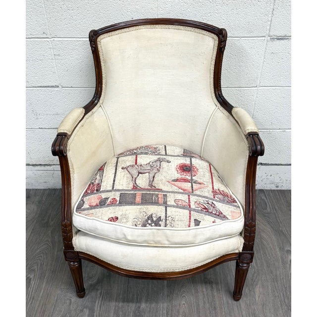 This is an elegant antique French Louis XVI style equestrian bergère armchair, believed to be from between 1890-1920....