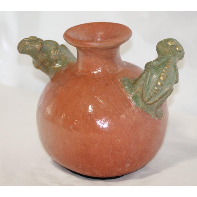 This is a fun, unique piece! Made from red clay, it has been fired at a high temperature and has a nice, even glaze. No...