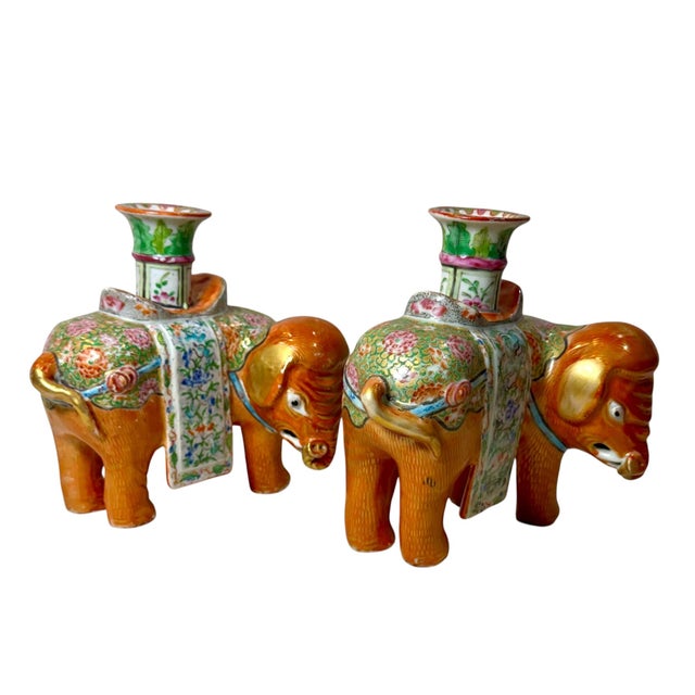 A wonderful matched pair of 19th century Chinese export rose mandarin porcelain candlesticks modeled in the form of...