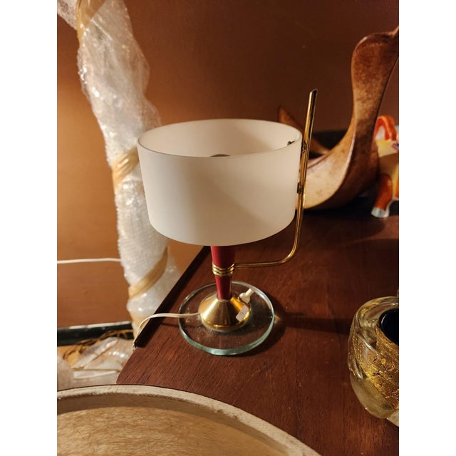 Table lamp with a cylinder shade and round base with detailed red enamel stem on a brass / glass base plastic shade...