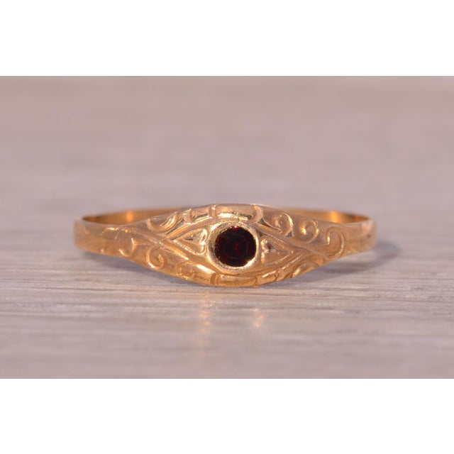 The Swan Hill: Childs Antique Garnet Ring in Yellow Gold. This ring centers on a round brilliant cut natural garnet....