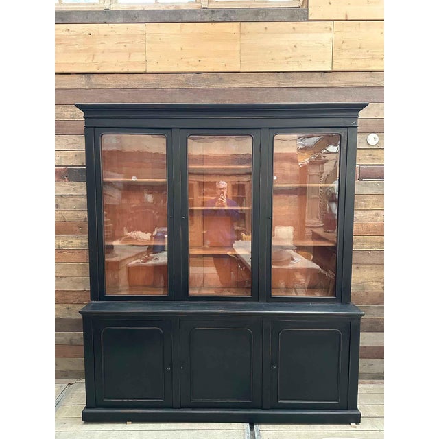 This late 19th-century bookcase has been fully restored. The upper section features three large, lockable glass doors that...