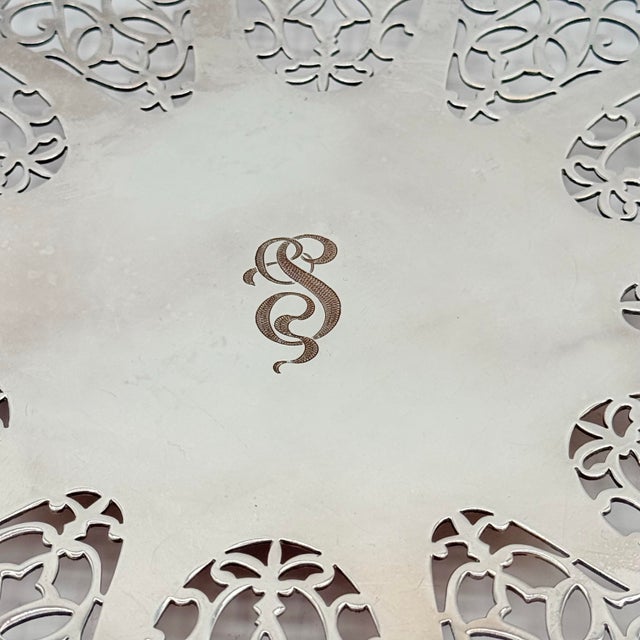 A beautifully decorative vintage silverplate trivet by International Silver Company, featuring an ornate pierced...
