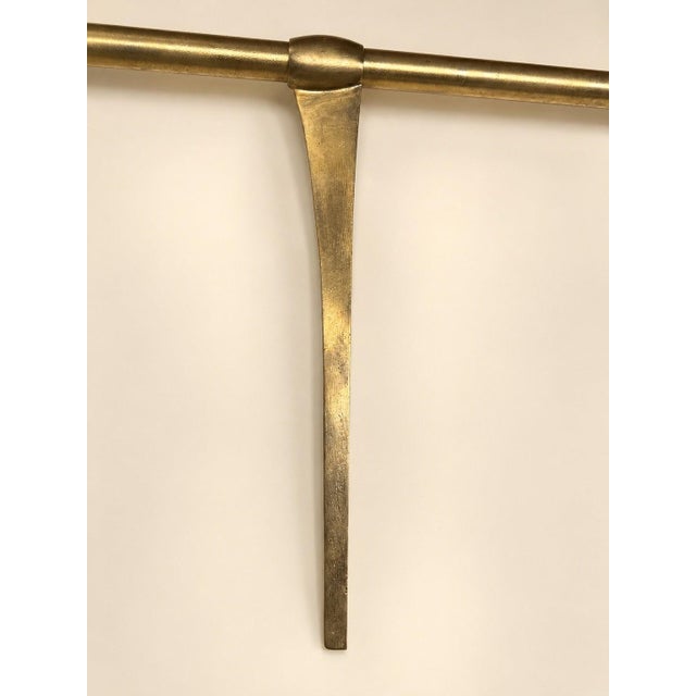 A belle époque commercial back-counter bar shelf made of solid brass tubing and glass shelves, dating from 1900-1920. it...