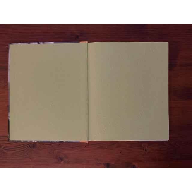 A beautifully illustrated book featuring a collection of dresses imitating historical paintings made of paper by the artist.