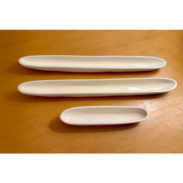 This vintage Carnevale McCarty of Memphis signed white pottery set of 3 olive tray dishes exudes a Mid-Century Modern...