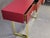 This refined Italian console table features a beautifully beveled red Murano glass top, complemented by three functional...