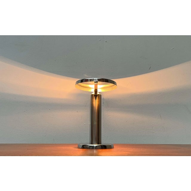 Minimalist table lamp with a movable head. A functional design. The lamp consists of a cylindrical tube as a base, which...