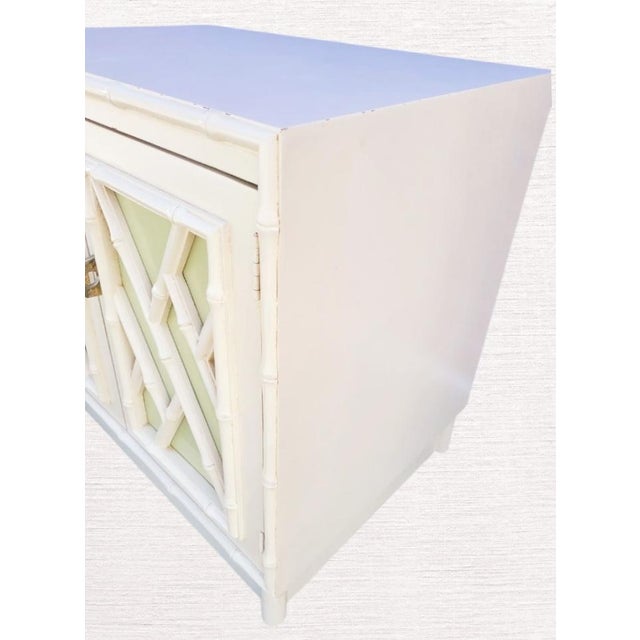 A pair of vintage 1970's chippendale and faux bamboo twin size headboards with 1 matching nightstand. The headboards have...