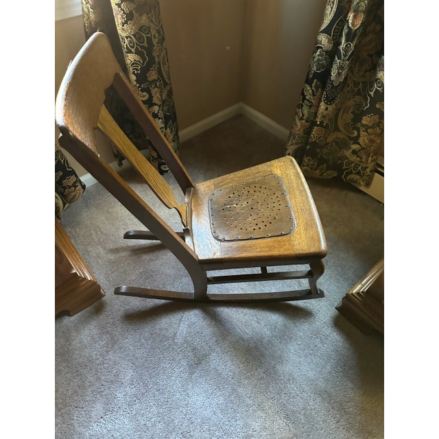 This is a C & A Kreimer of Cincinnati armless Rocking Chair. It dates to the turn of the 20th century. It's made of of oak.