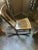This is a C & A Kreimer of Cincinnati armless Rocking Chair. It dates to the turn of the 20th century. It's made of of oak.