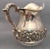 Sterling silver water pitcher by Hamilton & Diesinger, designed with beautiful floral decoration going around body and...