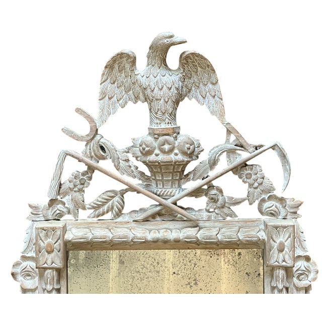 A remarkable neoclassical-style mirror by Chapman, hand-carved from solid wood with exquisite craftsmanship. The frame...