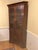 Beautiful traditional corner china cabinet crafted in rich cherry wood with elegant Colonial-inspired styling. Features a...