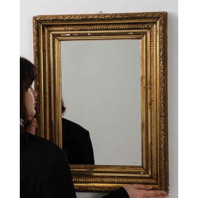 This mirror carries genuine presence, its gold gilt frame, rectangular immediately setting the tone for the piece. The...