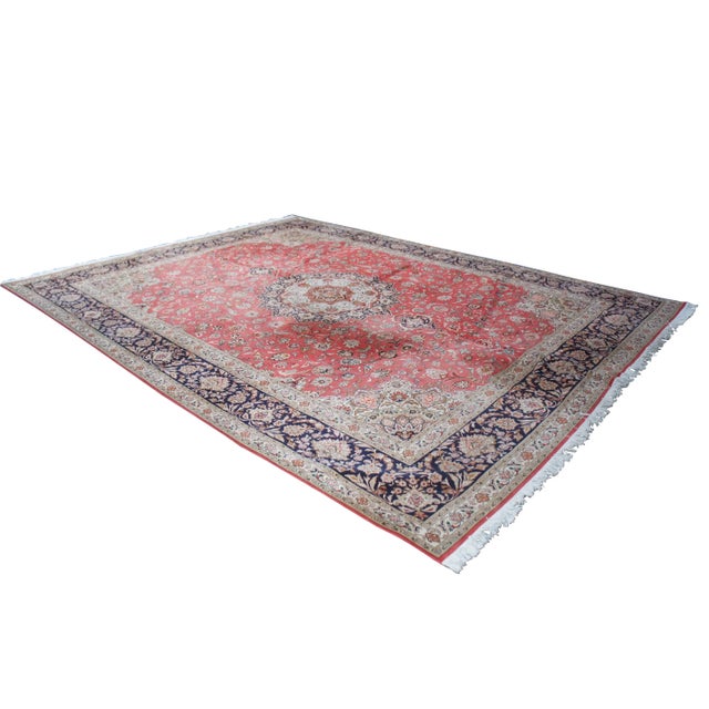 Very high quality hand knotted silk and wool pile area rug featuring a red field with central medallion and floral all...