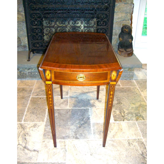 A particularly fine Pembroke made by Councill Furniture. In figured mahogany With a cross banded apron drawer flanked by...