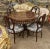 This beautiful set includes a table and 4 chairs. The table has a unique marquetry design with gold details on the legs,...