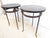 This pair of 24"H side tables have iron bases with a bronze finish and lion head medallions with marbleized wooden tops.