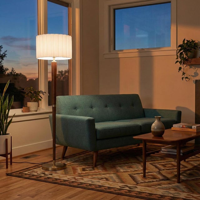 Bring vintage charm and warm ambiance to your space with this beautifully crafted floor lamp. The solid wood base features...