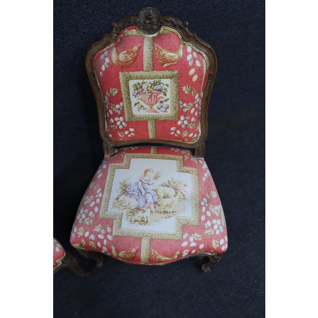 Pair of Louis XV style carved walnut side chairs with shaped backs and cabriole legs. Upholstered in a decorative toile...