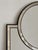 In excellent condition. This mirror features a black frame with segmented mirrored border panels and a circular upper...