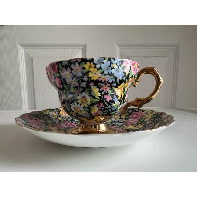 1940s , a vintage Queens Rosina Black Chintz Gold Cup & Saucer set. This set, made in England, is known for its vibrant...