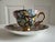 1940s , a vintage Queens Rosina Black Chintz Gold Cup & Saucer set. This set, made in England, is known for its vibrant...