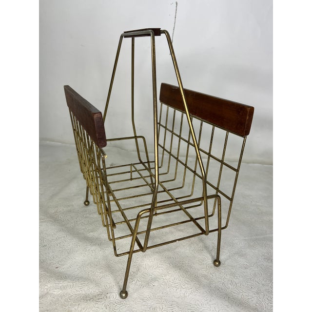 This is a very nice vintage modern magazine holder, made out of metal and walnut.