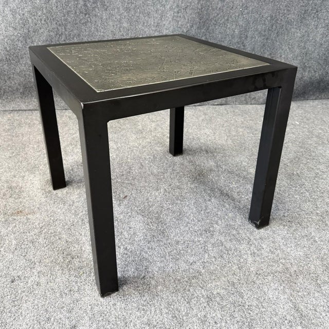 This Charleston Forge metal side table features a sleek black frame and a distinctive textured top with a layered, organic...