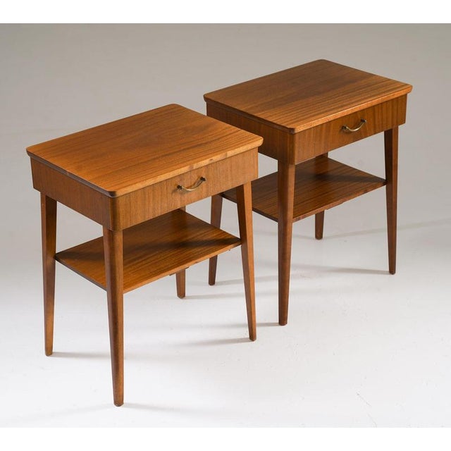 Swedish mahogany bedside tables from the 1940s. Featuring a simple yet functional design, each table has a single drawer...