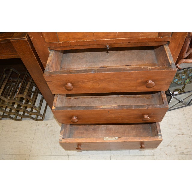 This is a unique cupboard. I believe it to be pine. Single door opens to a fixed shelf inside. 3 lower drawers & center,...