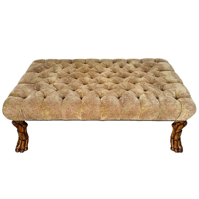 Large-scale upholstered ottoman coffee table made in the English Regency style and featuring deep diamond tufting across a...