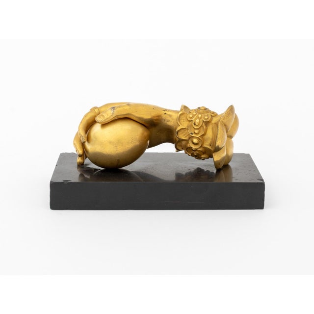 Victorian Hand Form Gilt Bronze Door Knocker, with an egg in palm mounted atop a black marble plinth. Overall: 3" H x...