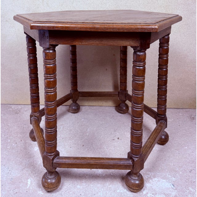 Charming Spanish hexagonal side table crafted from wood, featuring a distinctive geometric top with a subtly framed...