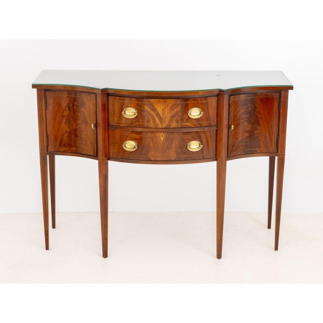 Hickory Chair Company Flame Mahogany Sideboard, with string inlay, two central drawers flanked by two cabinets mounted on...