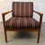 Mid-Century Modern wooden armchair showcases a classic Scandinavian design ethic featuring a sculptural wooden frame...